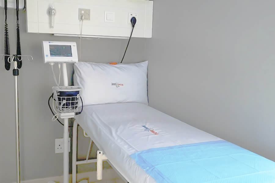Doctor consulting a patient in a private bay